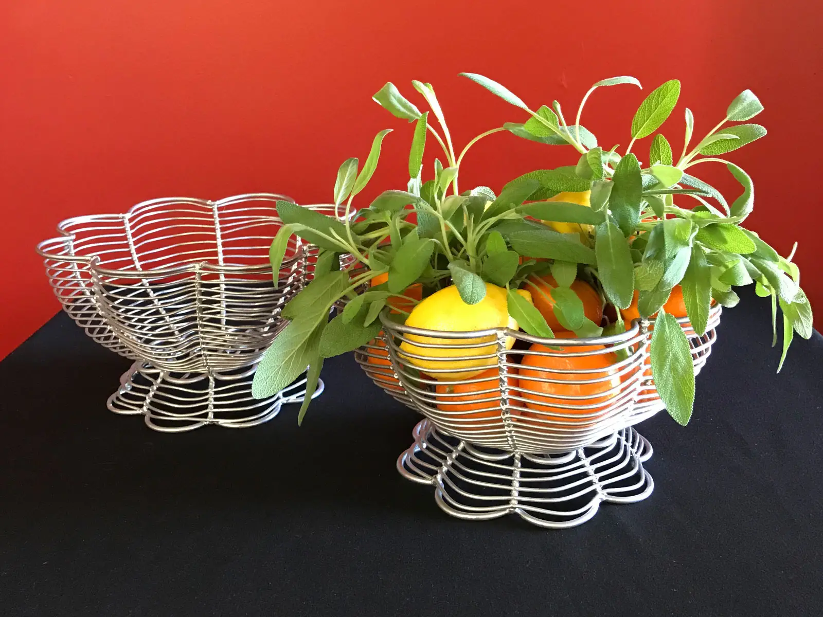 Several wax fruit centerpieces including oranges and lemons in white baskets Several wax fruit centerpieces including oranges and lemons in white baskets