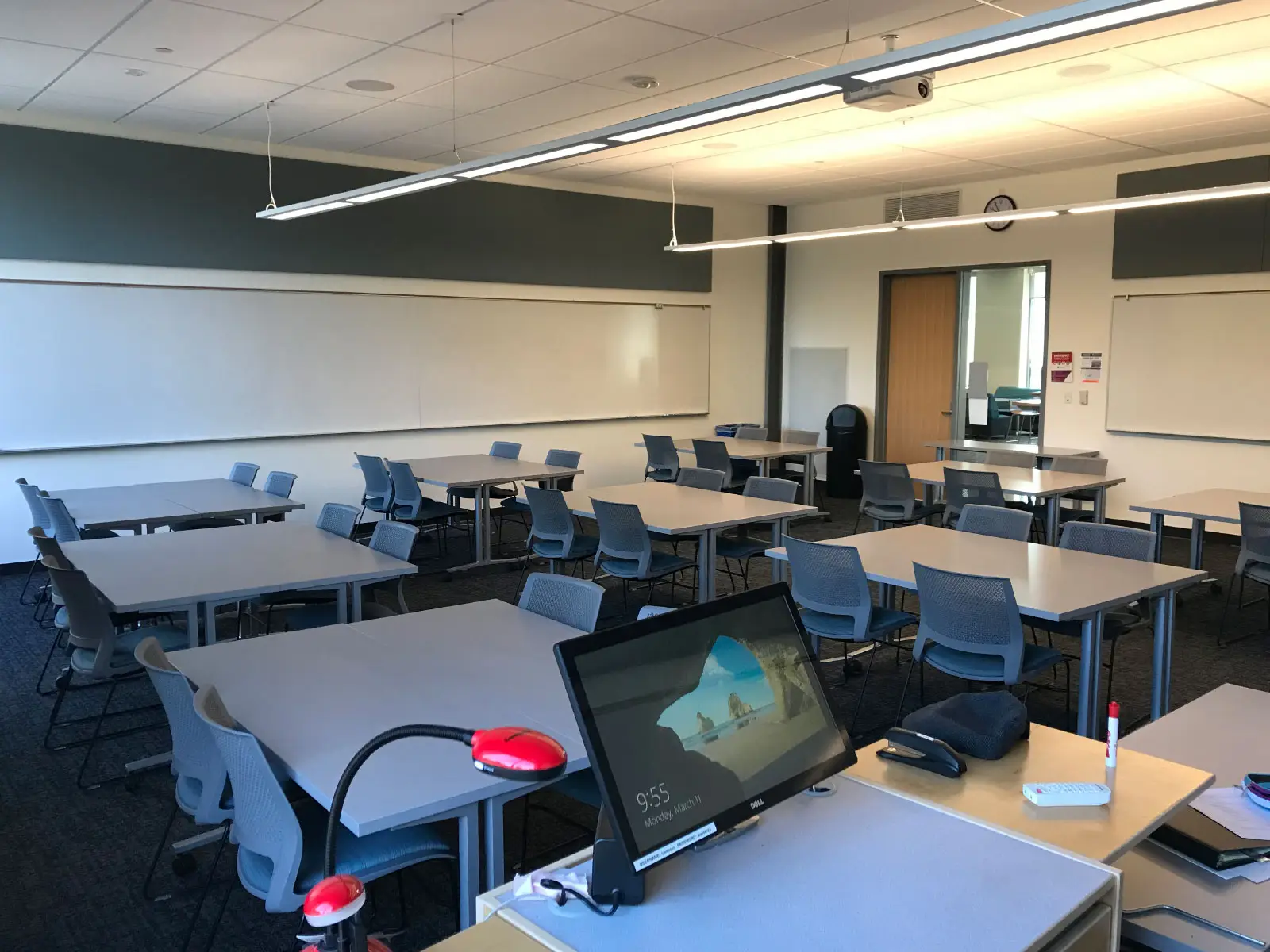 Several tables with chairs in front of a podium in a Oregon City campus classroom Several tables with chairs in front of a podium in a Oregon City campus classroom