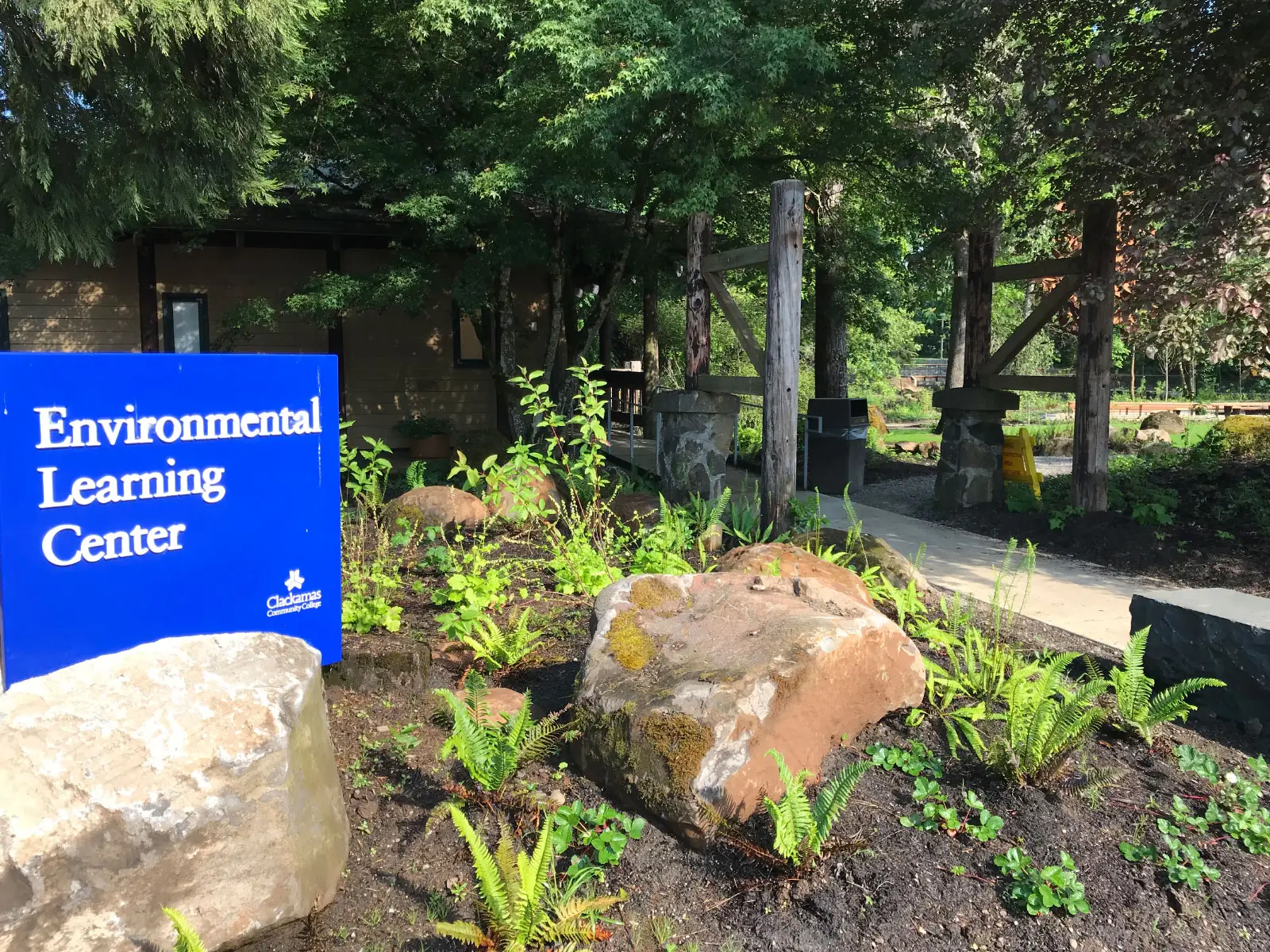 The Environmental Learning Center's blue entrance sign, surrounded by rocks and greenery, just outside Lakeside Hall, at the Oregon City campus The Environmental Learning Center's blue entrance sign, surrounded by rocks and greenery, just outside Lakeside Hall, at the Oregon City campus