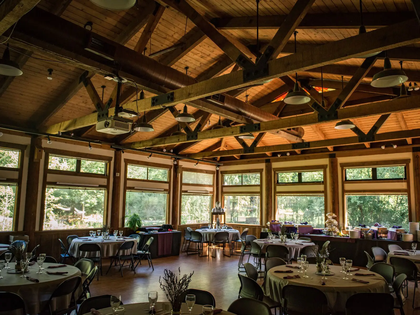 The inside of the Environmental Learning Center's Lakeside Hall, featuring decorated tables, glassware and catered drinks The inside of the Environmental Learning Center's Lakeside Hall, featuring decorated tables, glassware and catered drinks