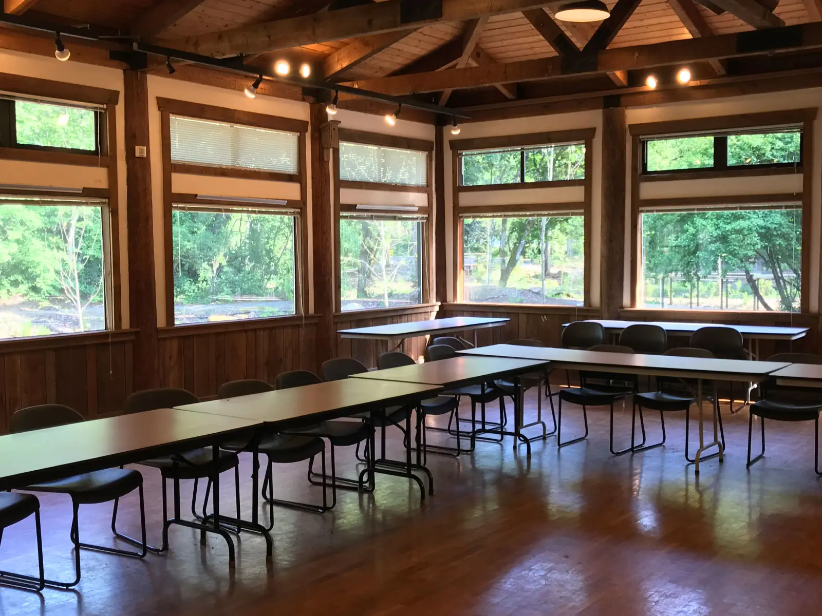 The inside of the Environmental Learning Center's Lakeside Hall, with rows of conference tables chairs