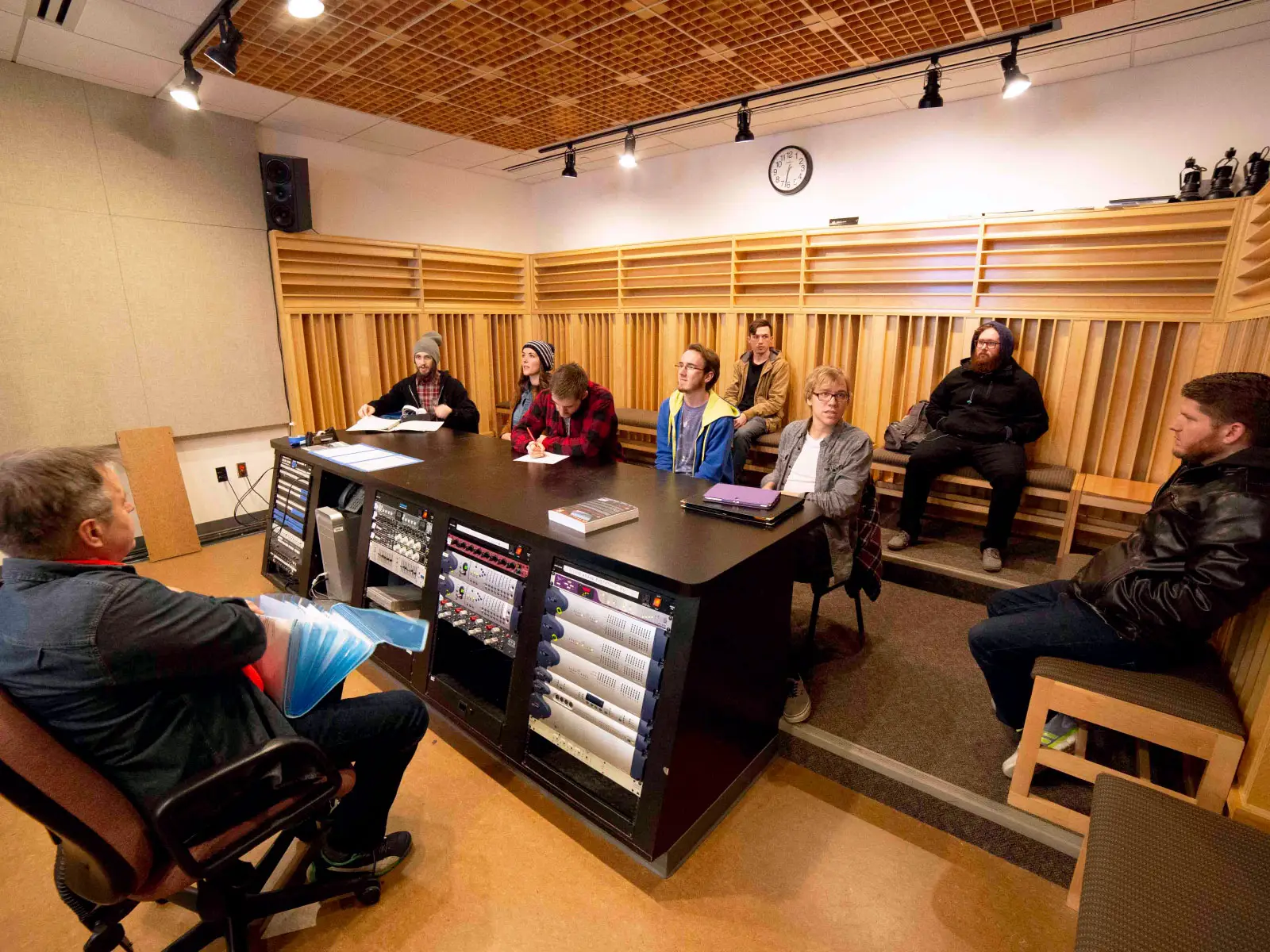 Students sitting around audio computer hardware, taking notes during an instructor's lecture in Niemeyer Center Students sitting around audio computer hardware, taking notes during an instructor's lecture in Niemeyer Center